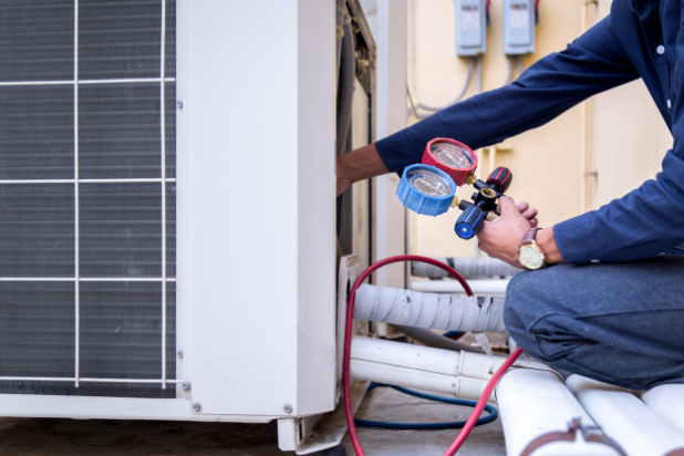 Technician is checking the air conditioner and measuring equipment.