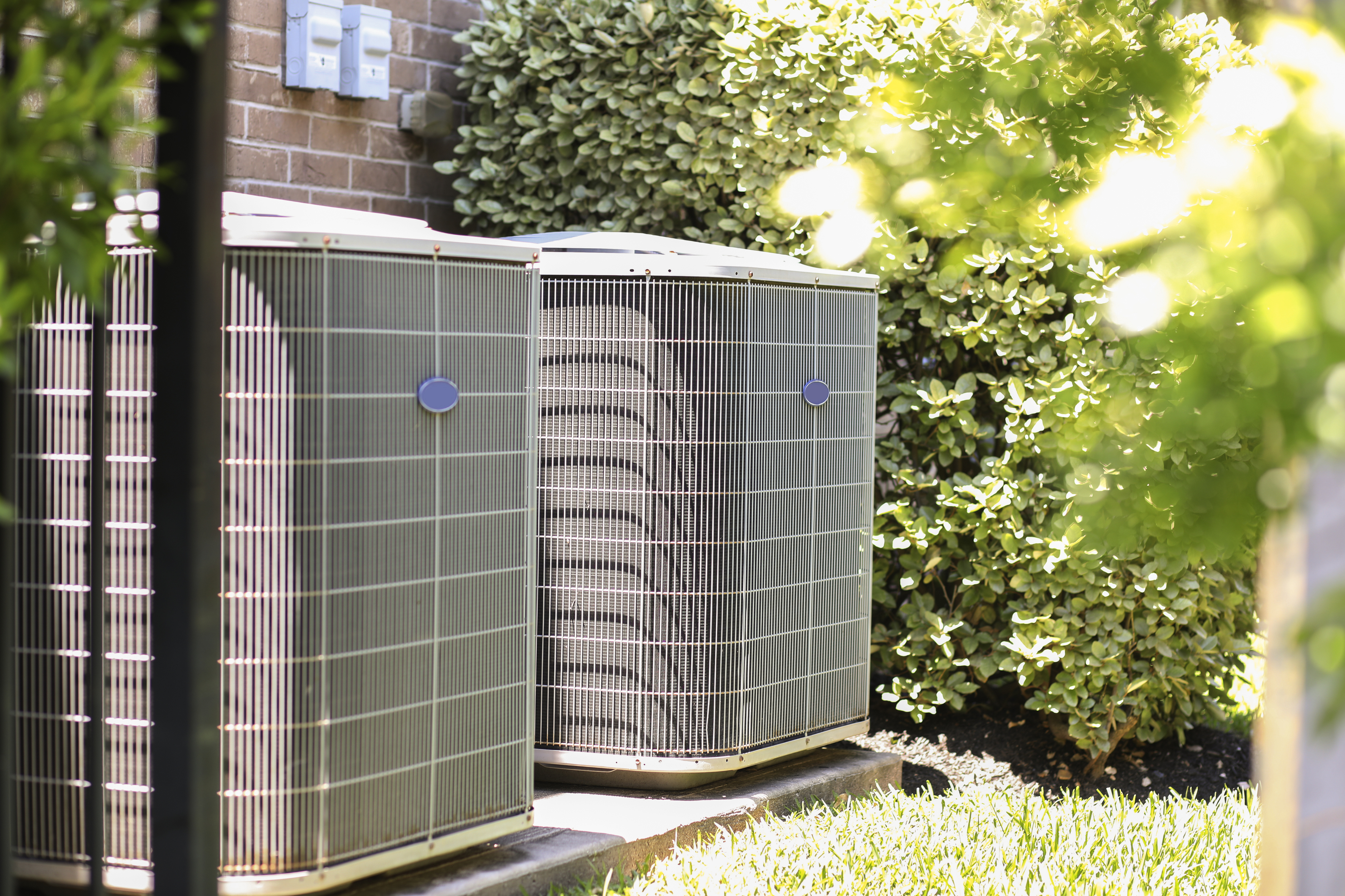 Two Carrier air conditioner units outside in Detroit MI.
