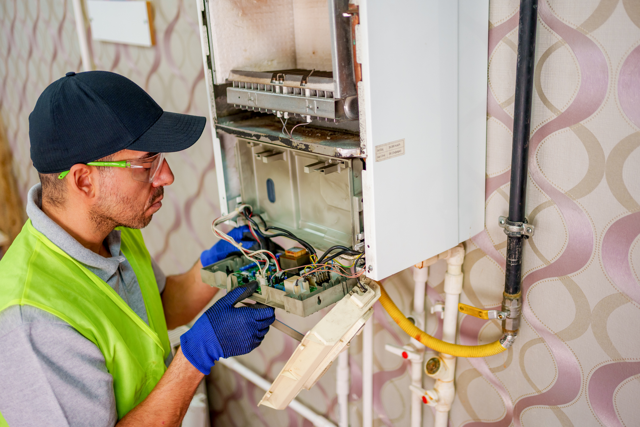 A technician performs maintenance on a furnace