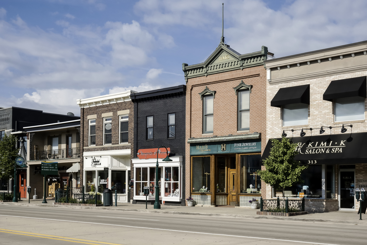 View of Main Street in downtown Rochester, Michigan, lined with shops and buildings on a sunny day.